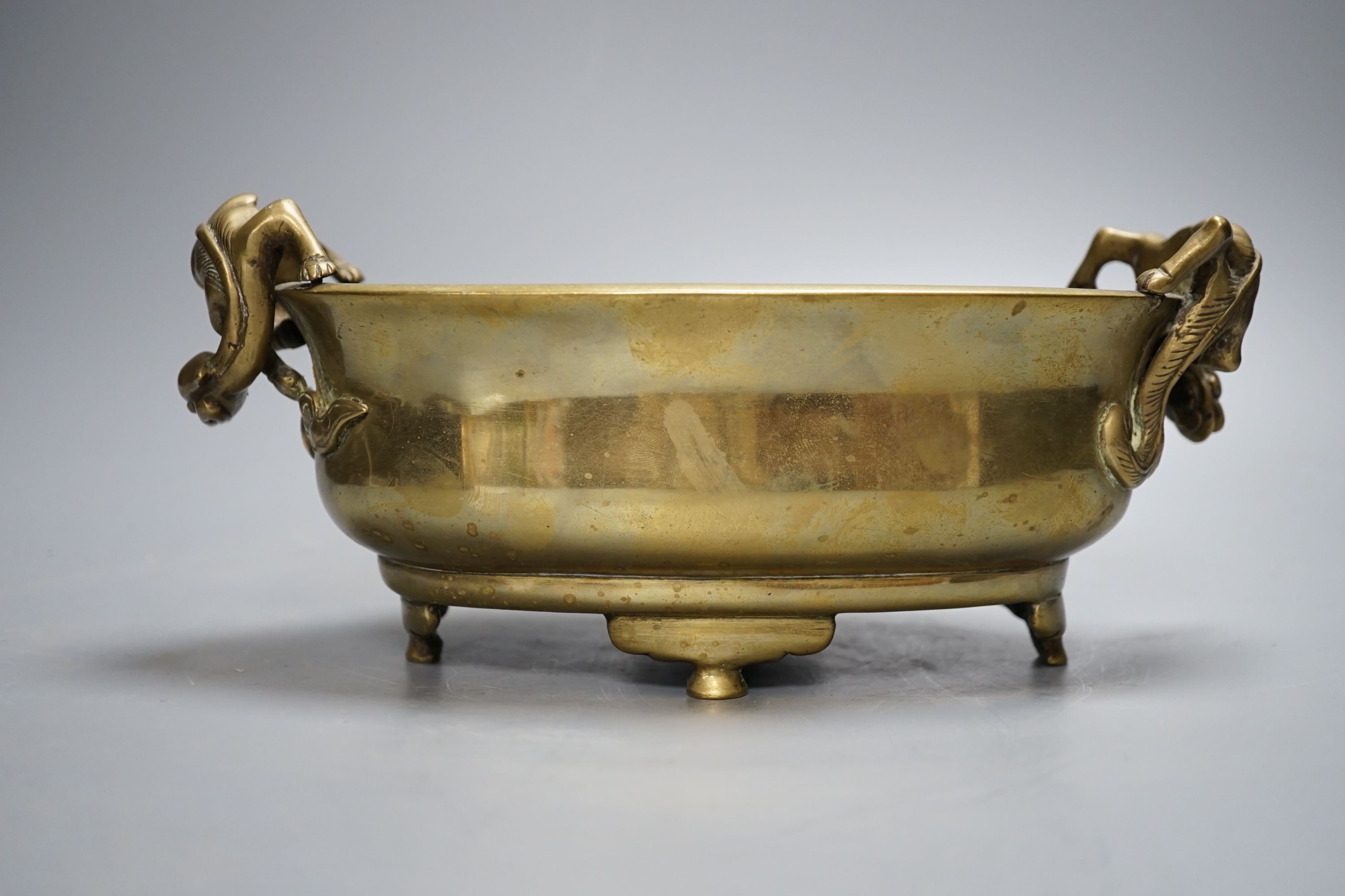 A 19th century Chinese bronze censer with ‘dragon’ handles, Xuande mark, 26cm